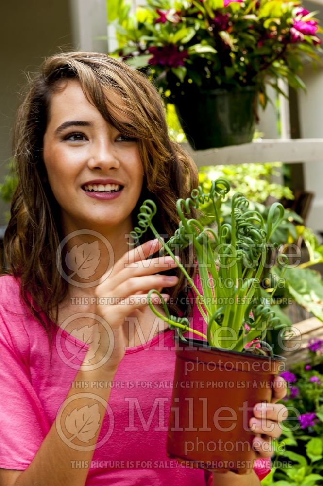 Young 14 year old girl with plant in garden (Ambiance) 34 